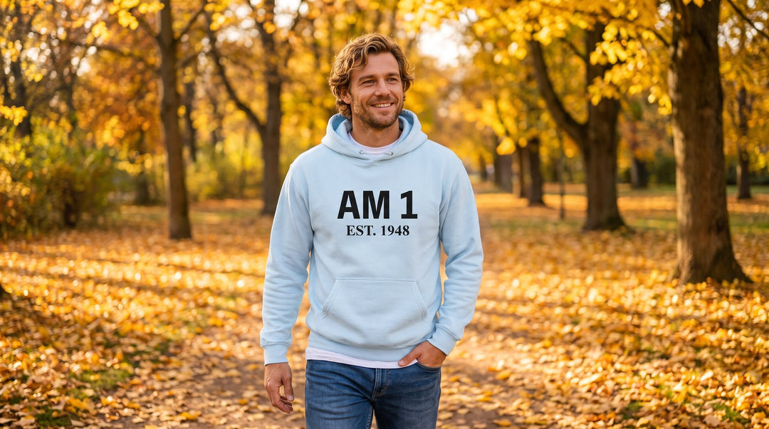 Man in a Jewish pride hoodie walking through an autumn park