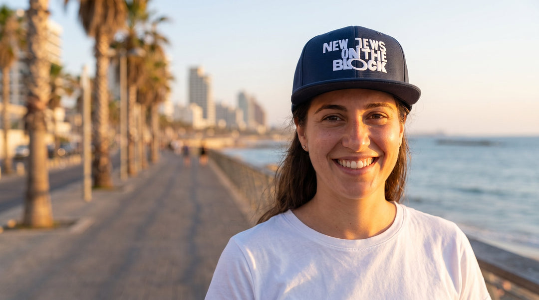 Woman wearing the New Jews on the Block Jewish snapback cap on the Tel Aviv beachfront promenade