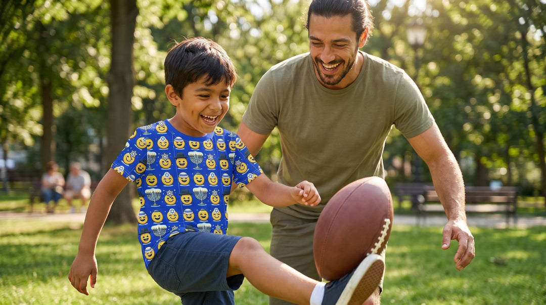 Boy in the Jewish Emoji kids t-shirt playing football with his father - emohtee kids all-over shirts