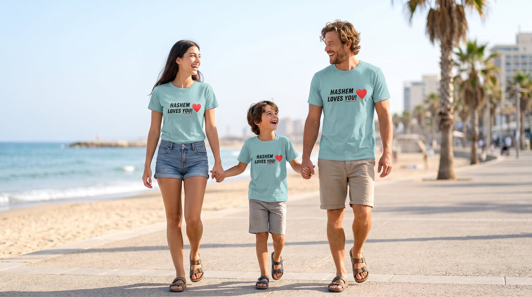 Family of three in matching Hashem Loves You t-shirts walking on the Tel Aviv beach promenade