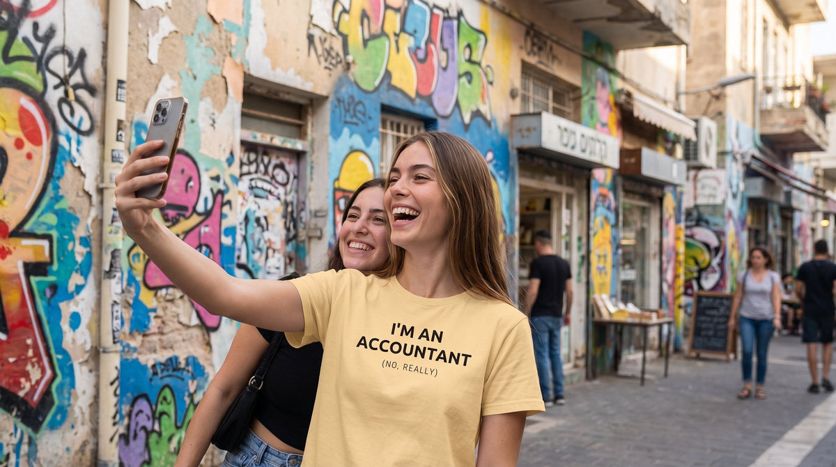 Accountant T-shirt worn by a woman in a colourful Florentin street with street art in Tel Aviv – MoT Member of the Tribe
