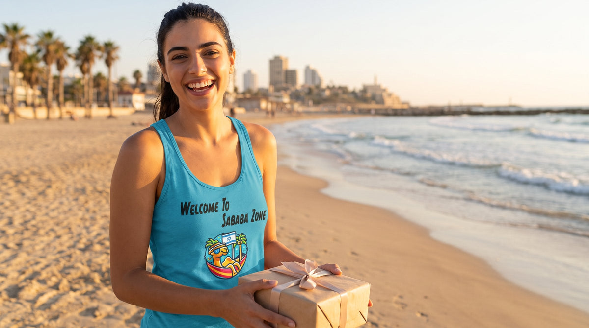Woman in the Sababa Zone racerback tank holding a gift on the beach - emohtee Jewish gifts for women