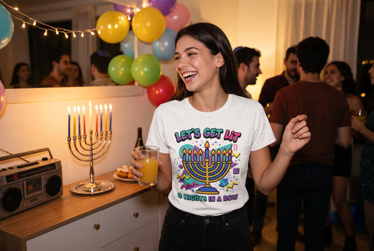Let's Get Lit 90s T-shirt worn by a woman laughing at a Hanukkah house party with a lit menorah and a retro boombox – MoT Member of the Tribe
