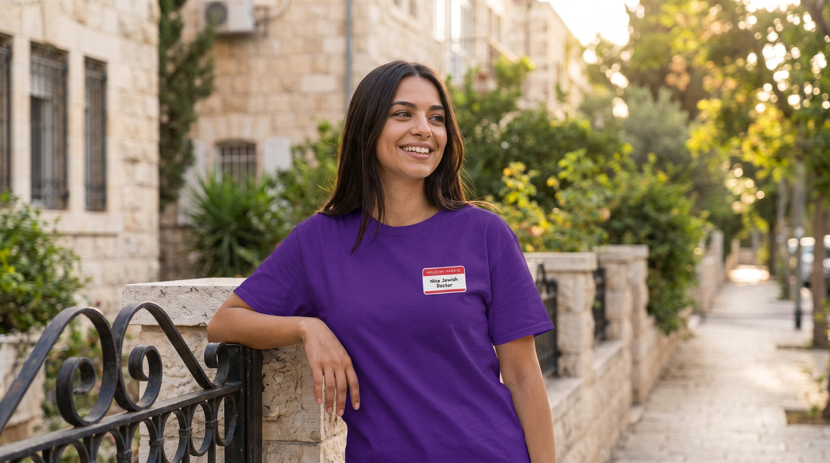 Nice Jewish Doctor T-shirt worn by a woman in a leafy residential street in Jerusalem – MoT Member of the Tribe