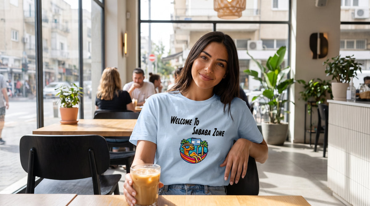 Sababa Zone T-shirt worn by a woman in a bright modern cafe in Tel Aviv – MoT Member of the Tribe