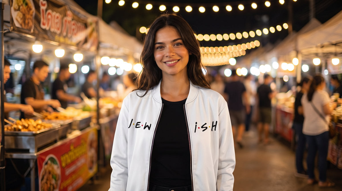 Woman in the J.E.W.I.S.H. bomber jacket at a night market - emohtee women bomber jackets