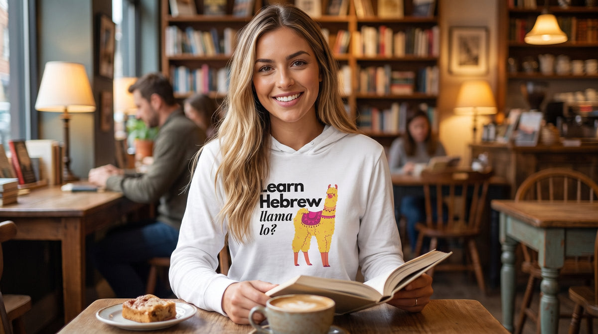 Woman in the Learn Hebrew Llama Lo hooded shirt in a bookshop cafe - emohtee women hoodies