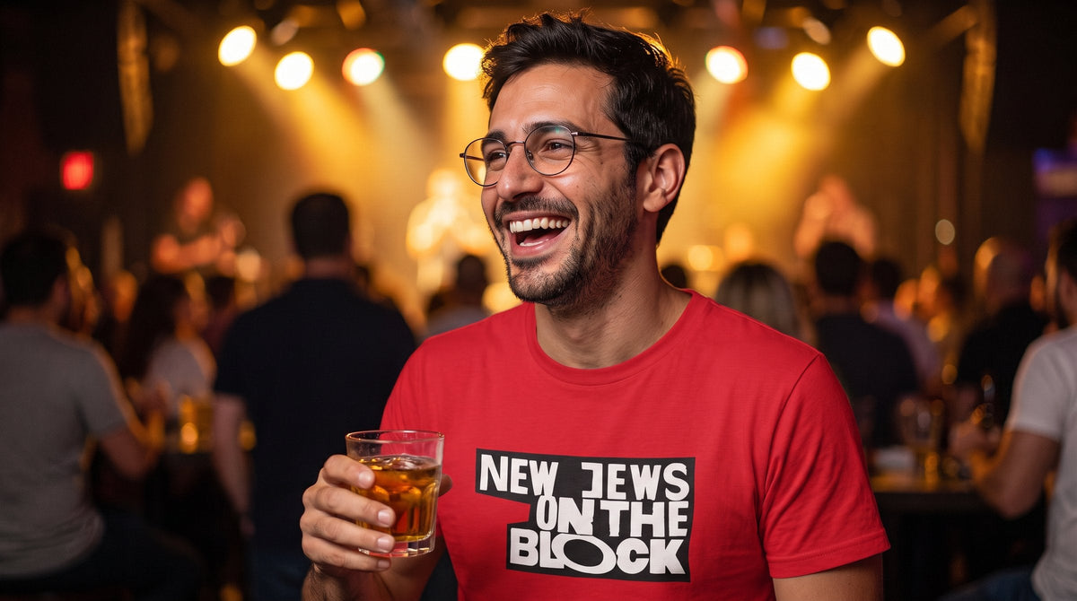 Man laughing in the New Jews on the Block tee at a comedy club - emohtee Yiddish shirts and Jewish humor