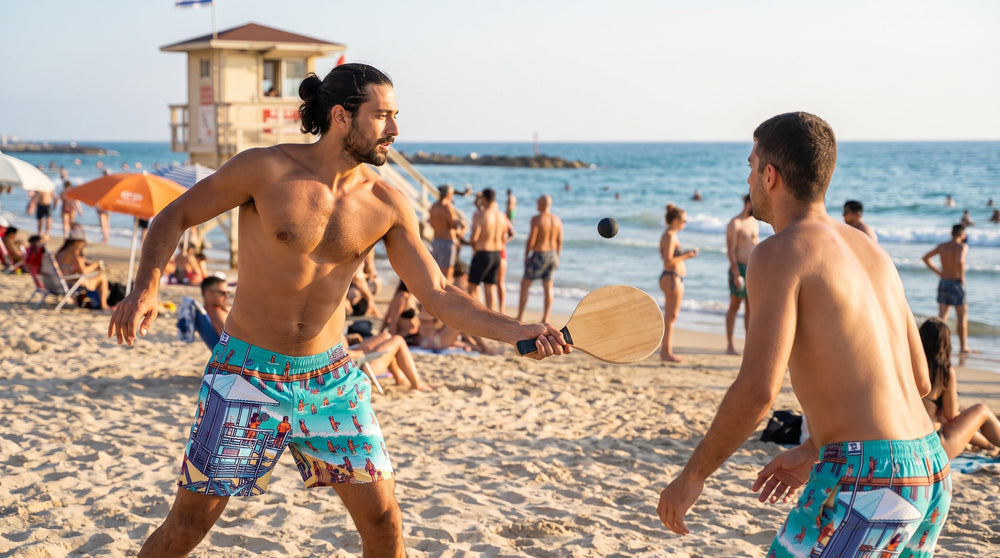 TLV Frishman Beach 16 Bit swim trunks worn by a man playing matkot at Frishman Beach, Tel Aviv – MoT Member of the Tribe