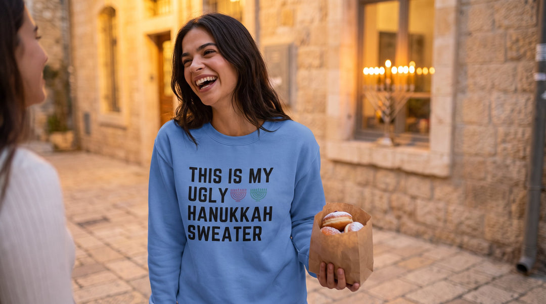 My Ugly Hanukkah Sweater sweatshirt worn by a laughing woman with sufganiyot on a Hanukkah evening in Jerusalem – MoT Member of the Tribe